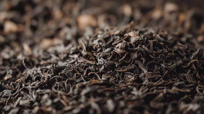 A close-up of loose-leaf dark tea, showcasing its rich, fermented texture and deep earthy tones, highlighting the complexity and aging process of Chinese dark tea.